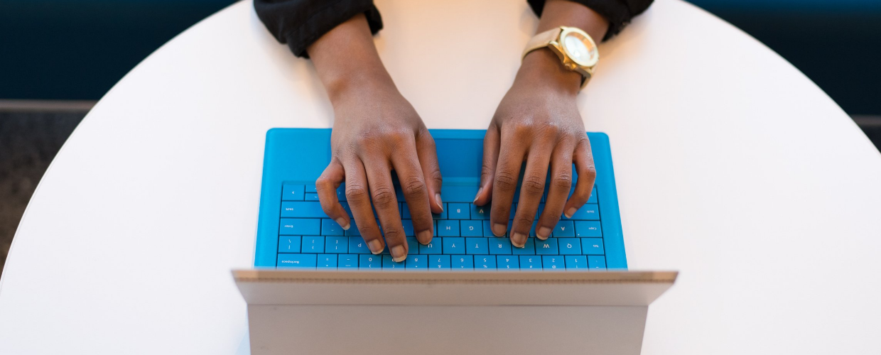 hands typing on a laptop keyboard